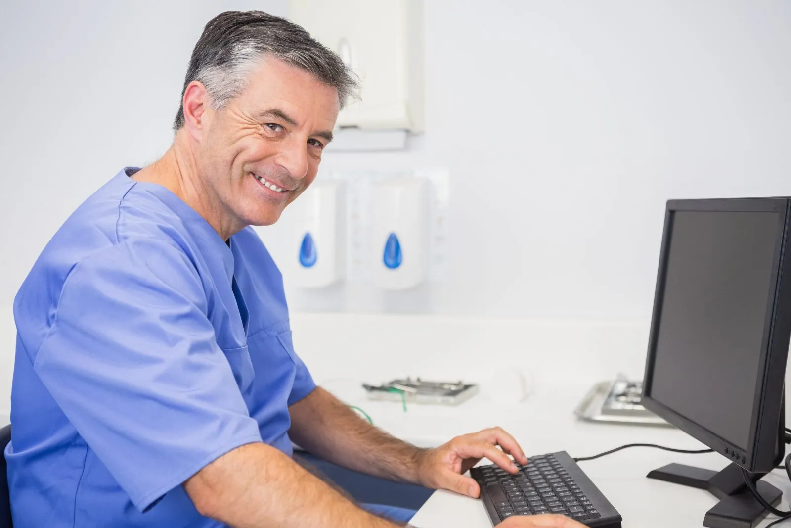 Dental practice owner at the office computer